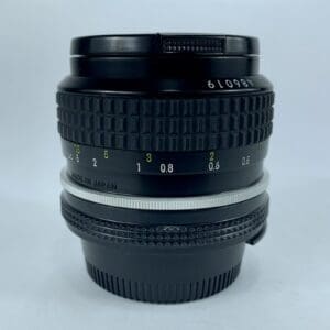 Camera lens with focus and aperture rings.