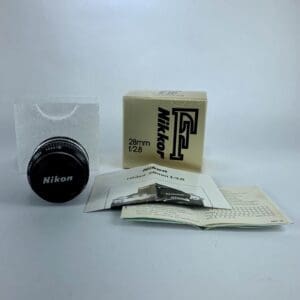 Nikon lens with box and manuals.