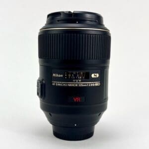 Nikon camera lens, black with visible labels.