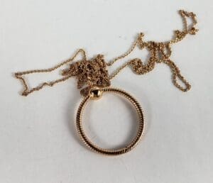 Gold twisted pendant on tangled chain.