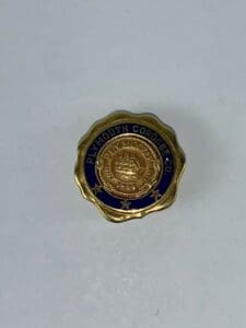 Gold Plymouth Cordage Co. pin on white.