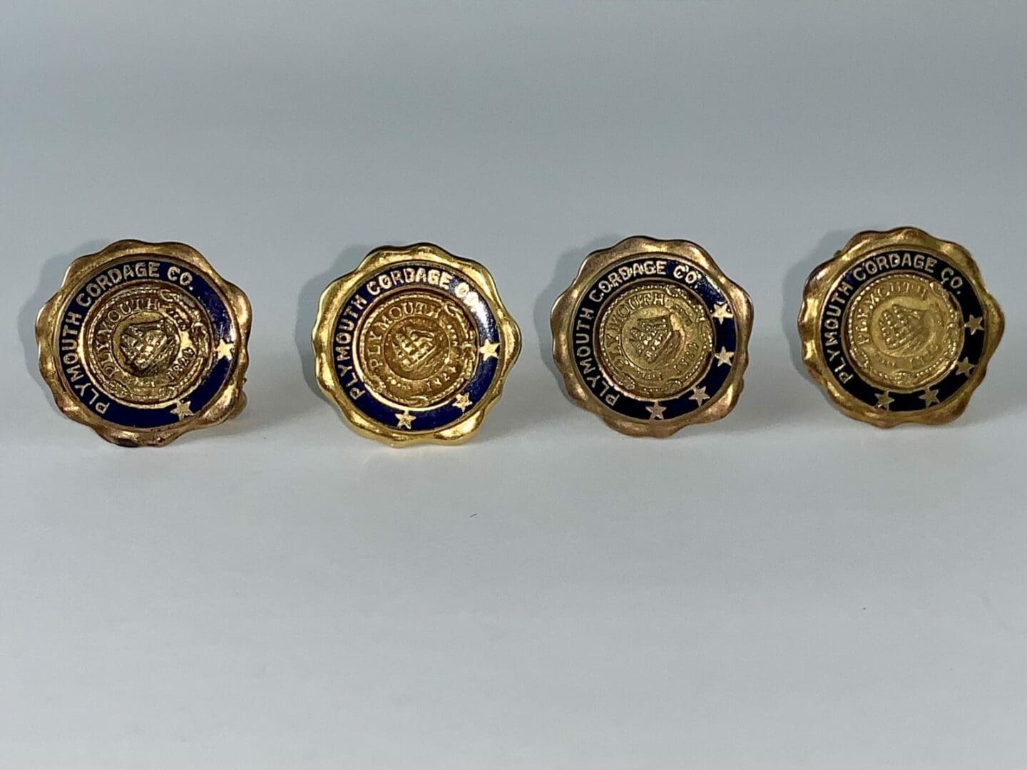 Four Plymouth Cordage Company buttons displayed.