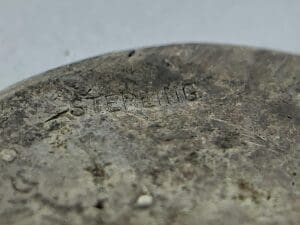 Close-up of a tarnished sterling silver item.
