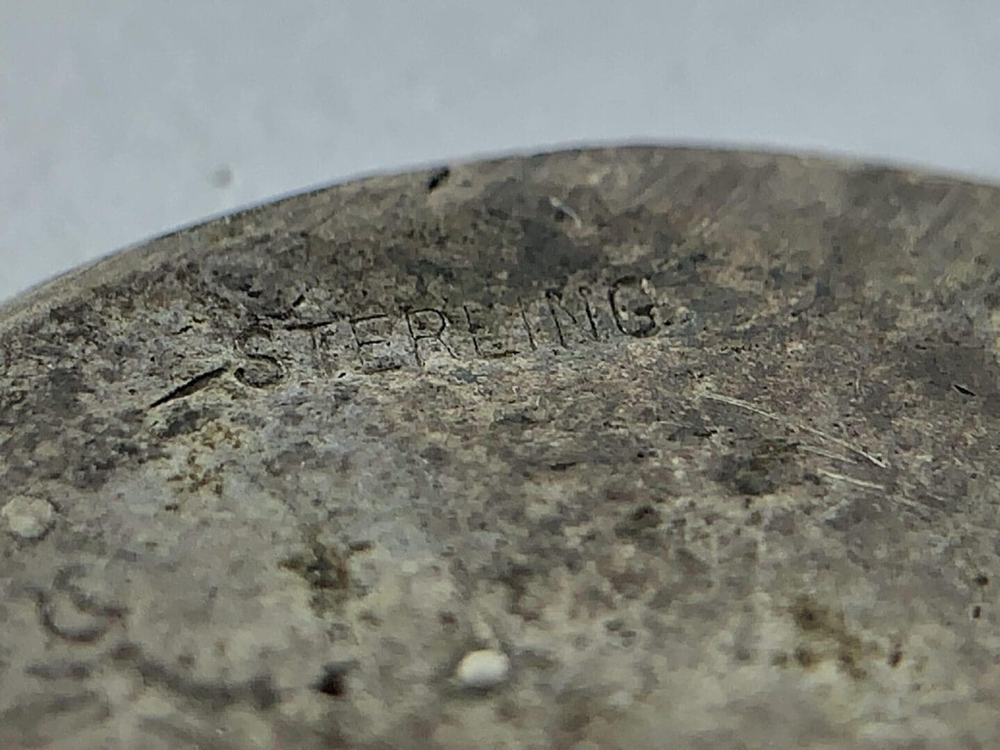Close-up of a tarnished sterling silver item.