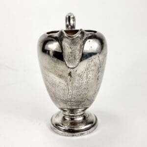 Silver-plated pitcher with a lid.