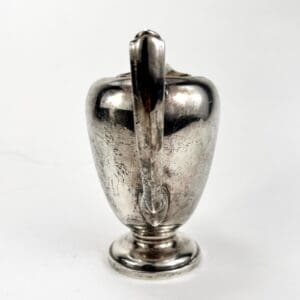 Silver vintage pitcher with handle.