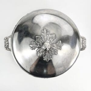 Silver dish with ornate floral design.