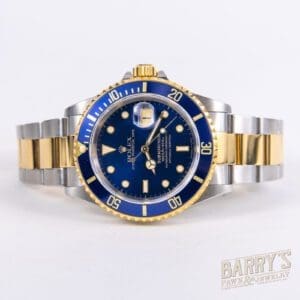 Gold and silver wristwatch with blue dial.