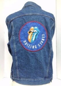 Denim jacket with Rolling Stones logo patch.