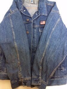 Denim jacket with American flag patch.