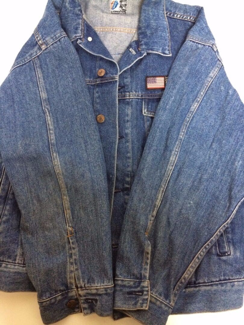 Denim jacket with American flag patch.