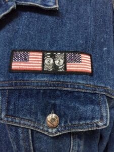 Denim jacket with American flag patch.