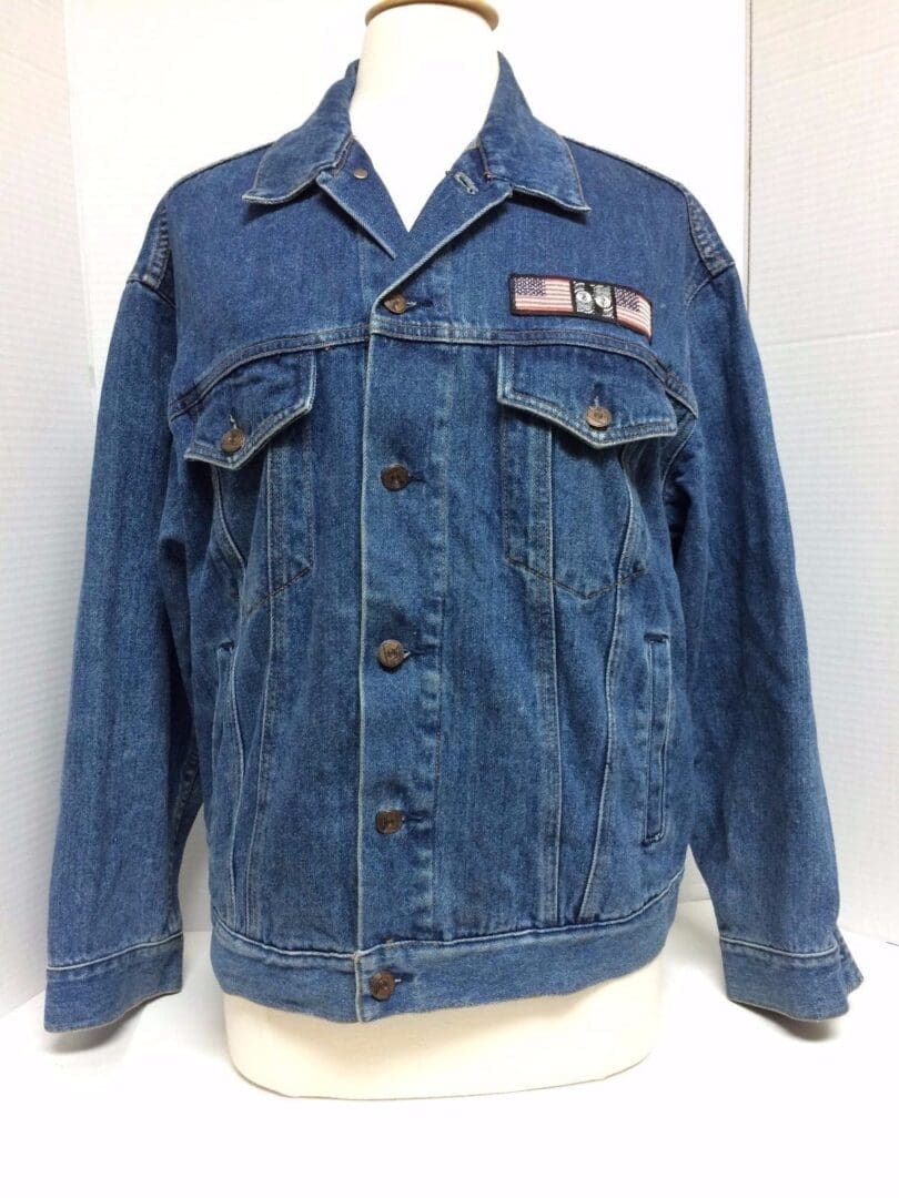 Denim jacket with American flag patch.