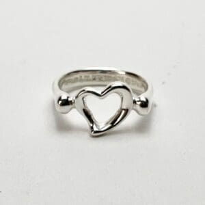 Silver ring with open heart design.