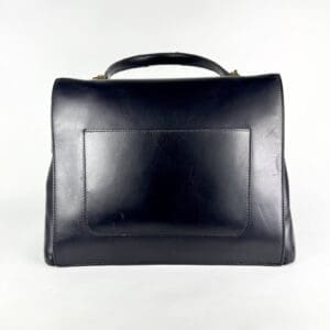 Black leather handbag with top handle.