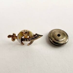 Medinah pin with detachable metal backing.