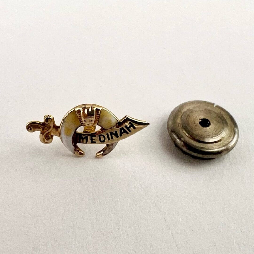 Medinah pin with detachable metal backing.