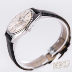 Silver wristwatch with black leather strap.
