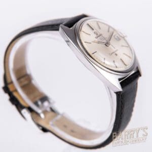 Vintage wristwatch with black leather strap.