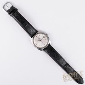 Black leather strap watch on white background.