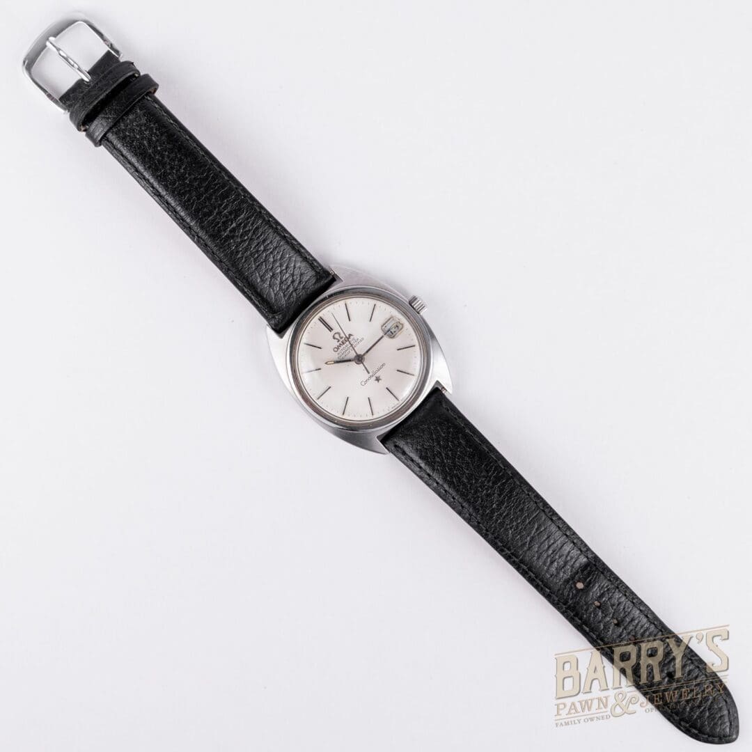 Black leather strap watch on white background.
