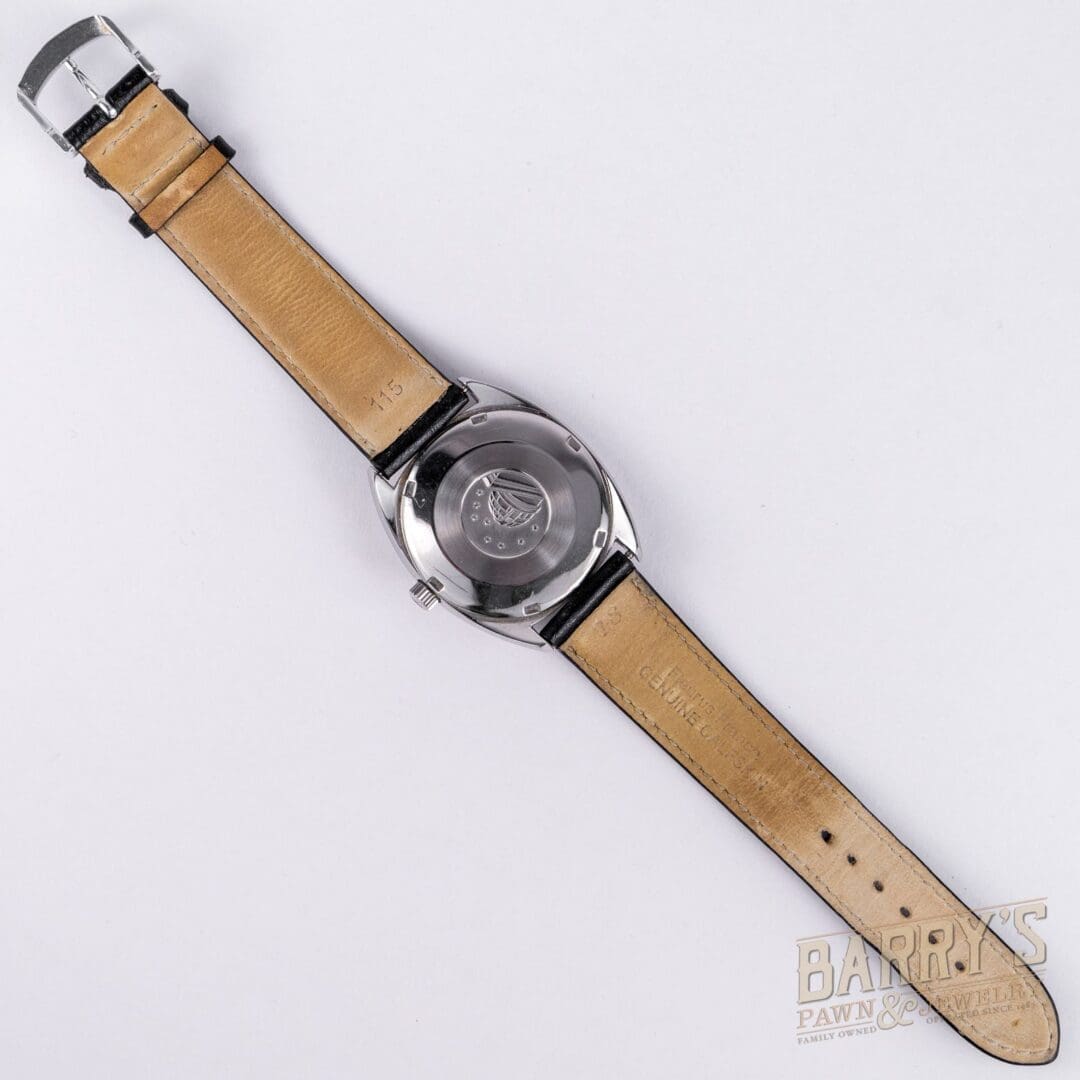 Watch with leather strap and metal buckle.