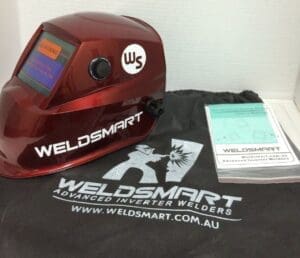 Welding helmet with Weldsmart branding and manuals.